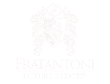 The logo for fratantonio luxury estates is a shield with a lion on it.