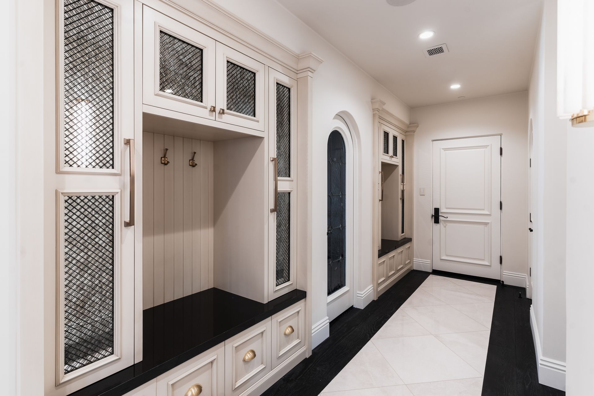 luxury mudroom with white custom cabinets