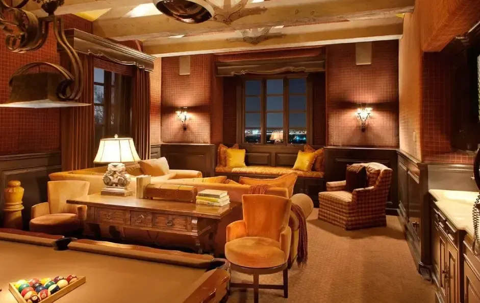 Billiards room with overhead multi-bulb light fixture