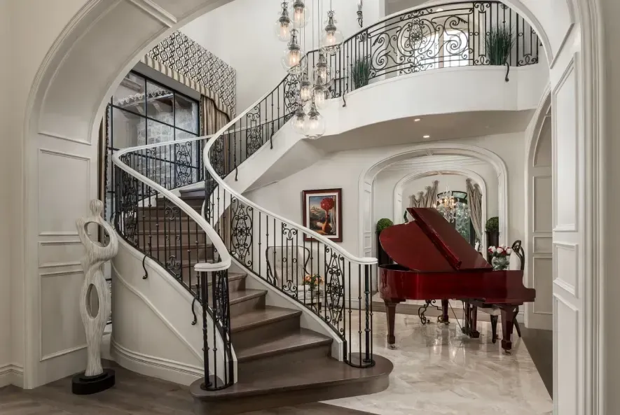 Luxury foyer with custom wrought iron staircase