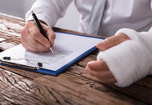 Civil Litigation — Man With Injured Hand Writing On Paper in Kennett, MO Civil Litigation — Man With Injured Hand Writing On Paper in Kennett, MO