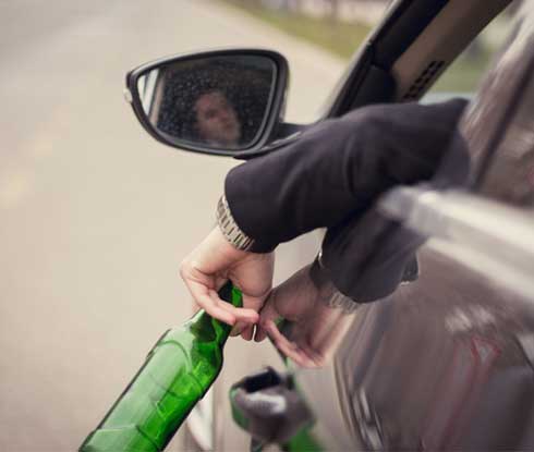 Criminal Law — Man Holding Out A Bottle Of Alcohol in Kennett, MO Criminal Law — Man Holding Out A Bottle Of Alcohol in Kennett, MO