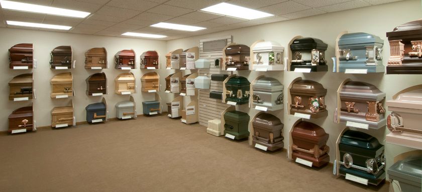 A room filled with lots of coffins of different colors