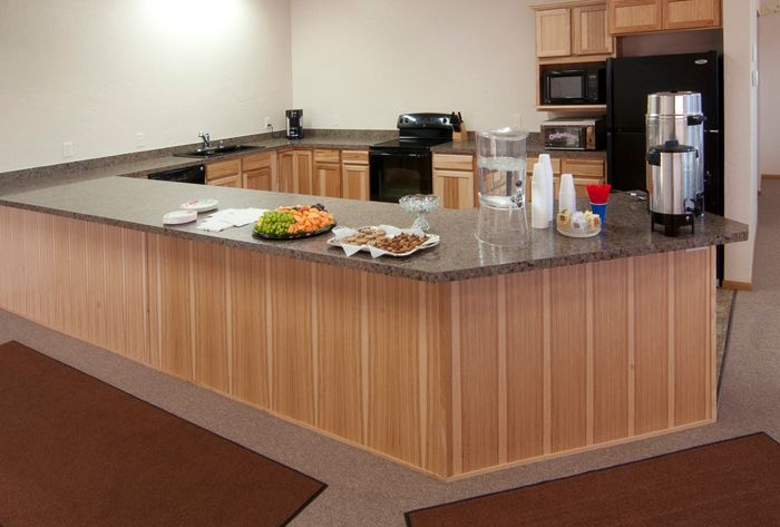 A kitchen with wooden cabinets and granite counter tops