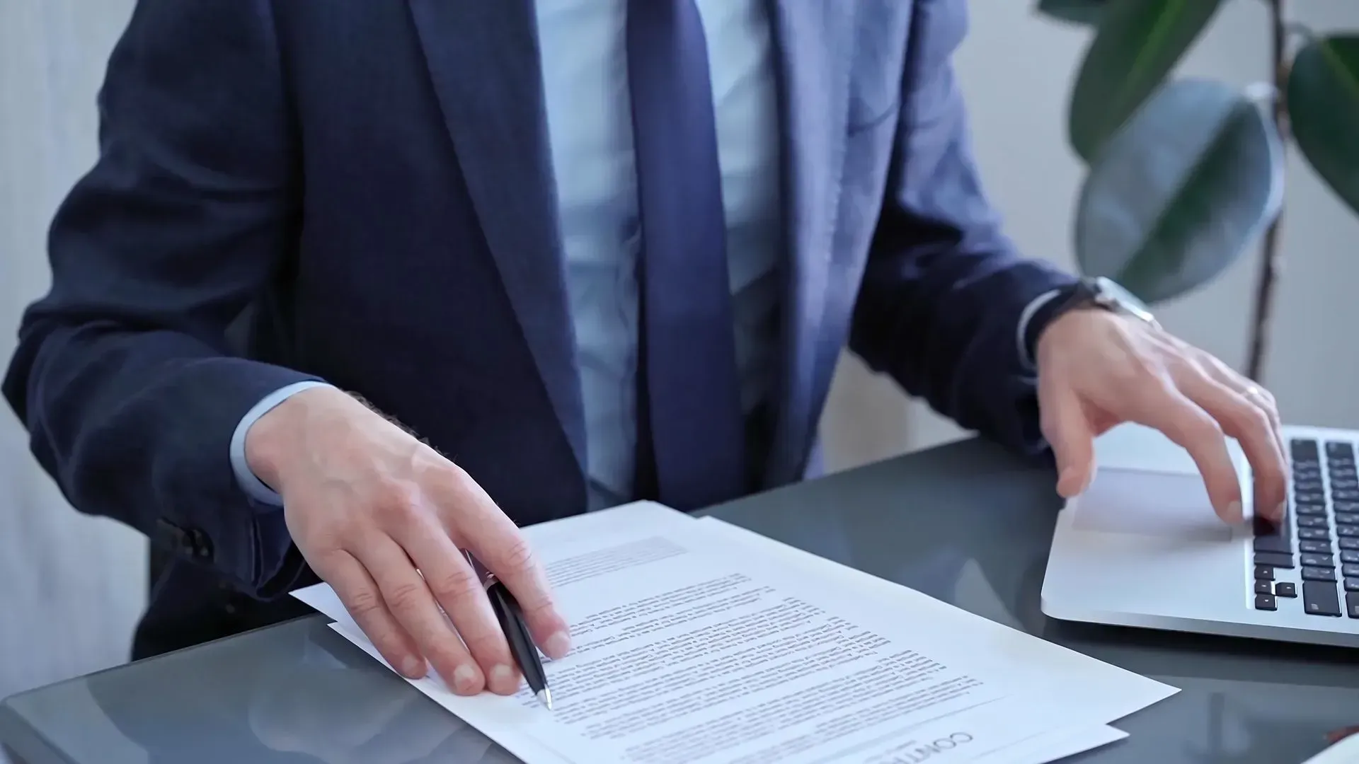 Man in Suit at Desk — Dwyer Law Group in Surfers Paradise, QLD