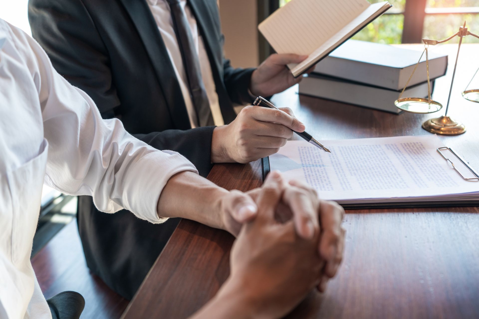 Lawyer Points to Document, Explaining to Client — Dwyer Law Group in Surfers Paradise, QLD