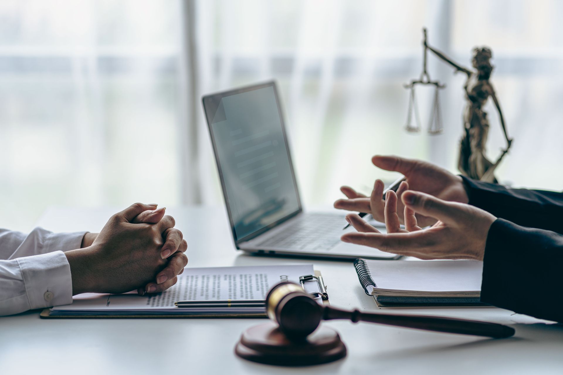 Hands Gesturing Near a Laptop — Dwyer Law Group in Surfers Paradise, QLD