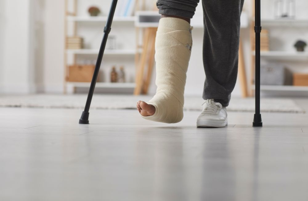 Person With Leg Cast Using Crutches to Walk Indoors — Dwyer Law Group in Surfers Paradise, QLD