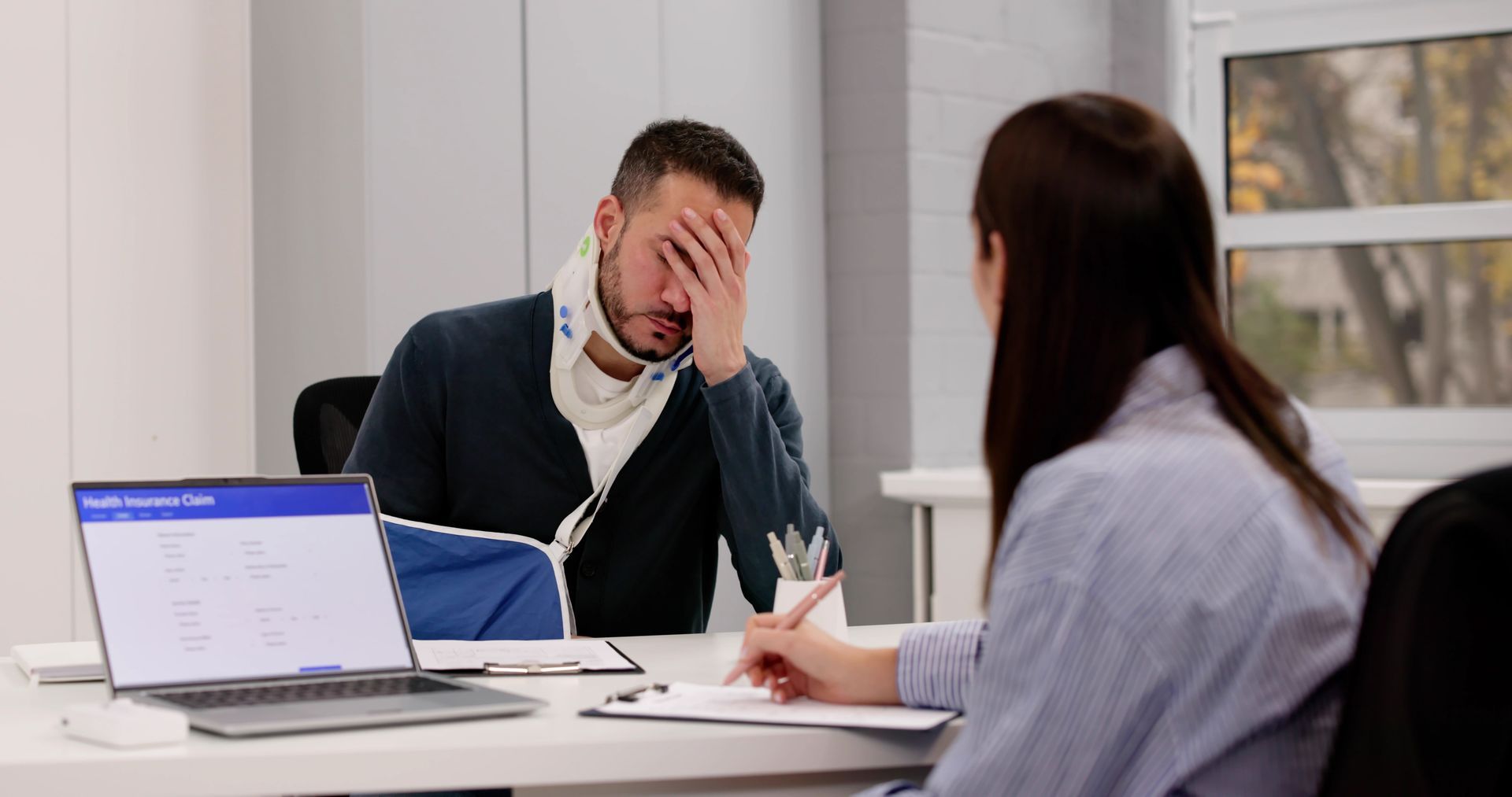 Man Consulting With a Lawyer Whilen Taking Notes at a Desk — Dwyer Law Group in Surfers Paradise, QLD