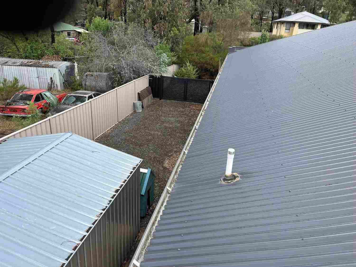 A Roof With a Gutter on It and a Fence in the Background — GUTTER MUNCHER In Bendigo, VIC