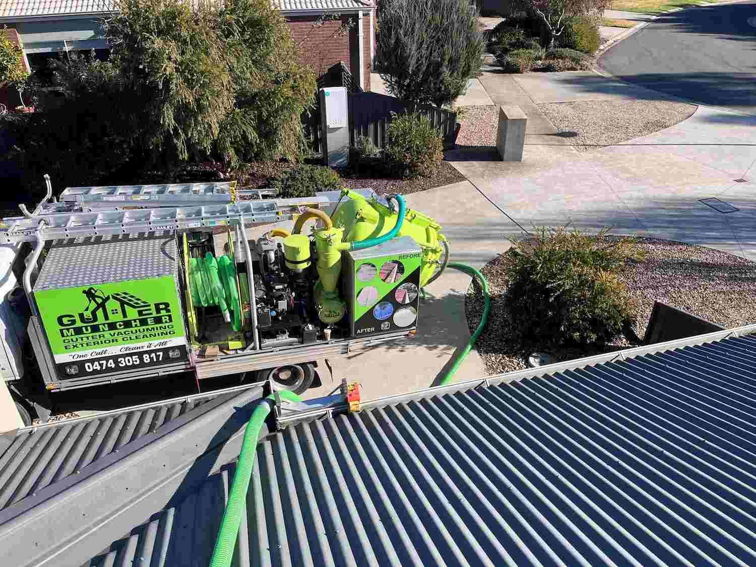 A Green Truck is Parked on the Roof of a House — GUTTER MUNCHER In Bendigo, VIC