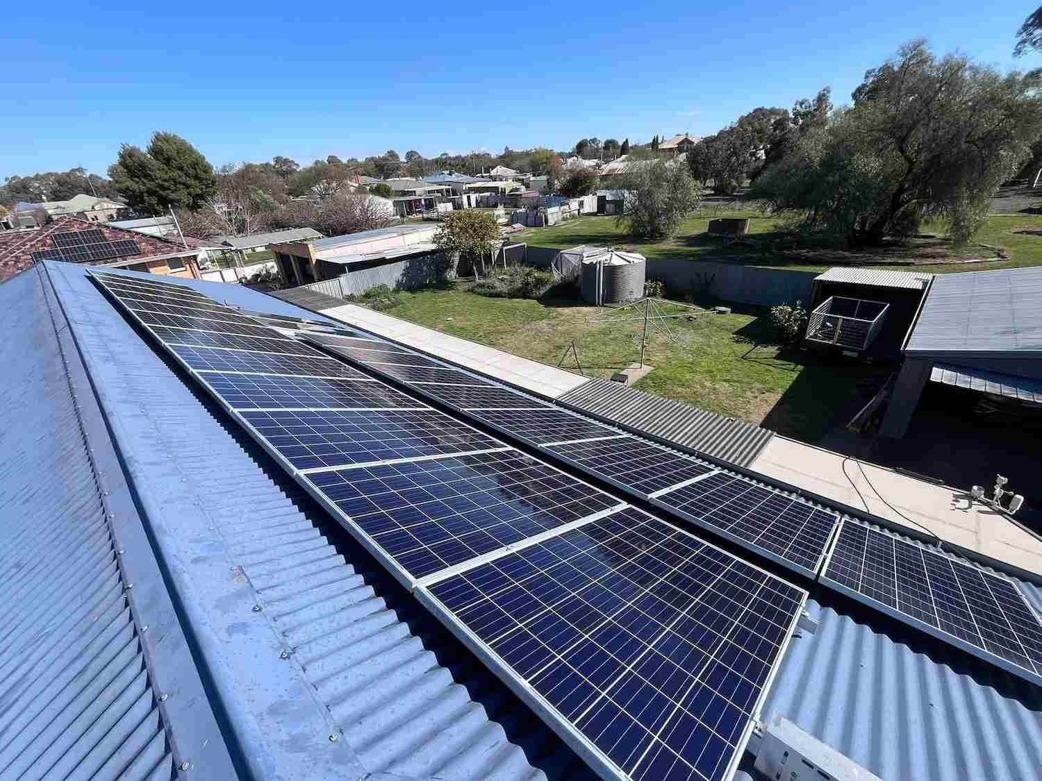 A Row of Solar Panels on the Roof of a Building — GUTTER MUNCHER In Huntly, VIC