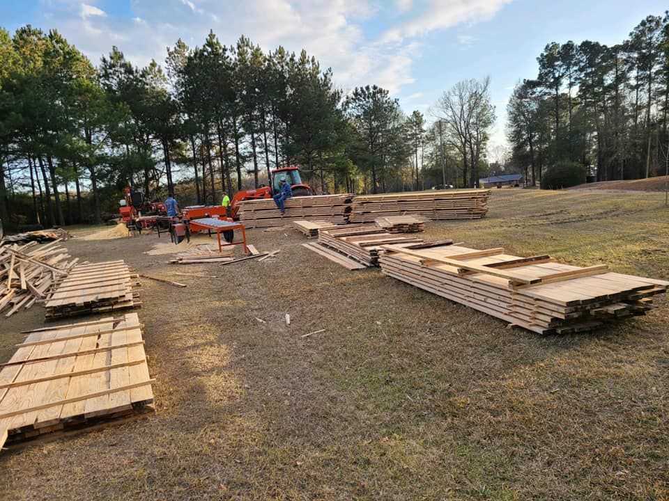 A bunch of wooden pallets are sitting on the ground in a field.