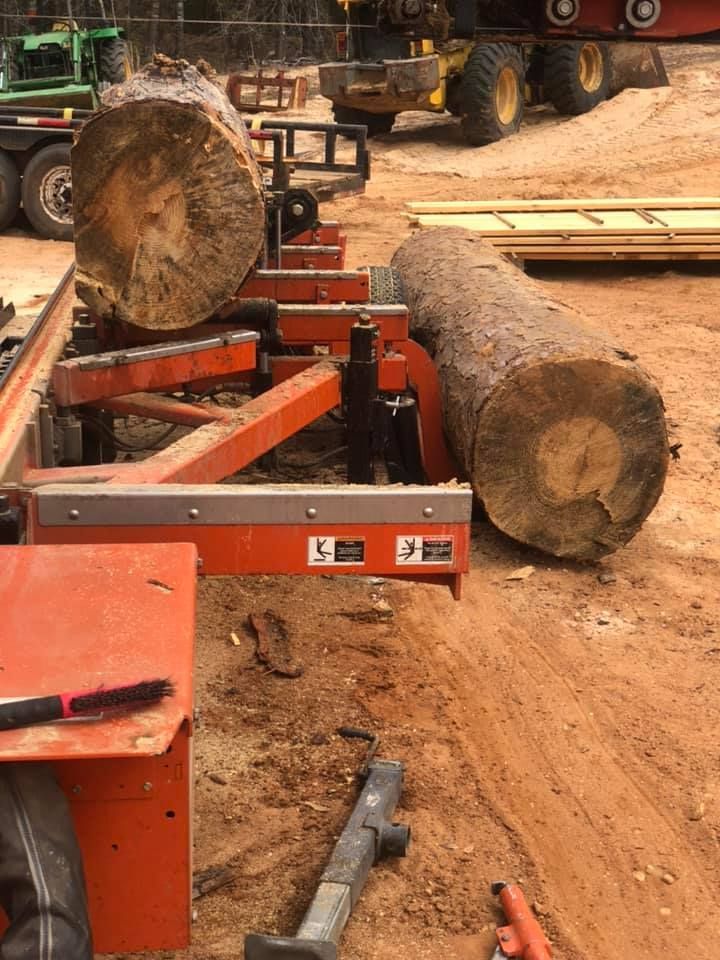 A large log is sitting on top of a machine.