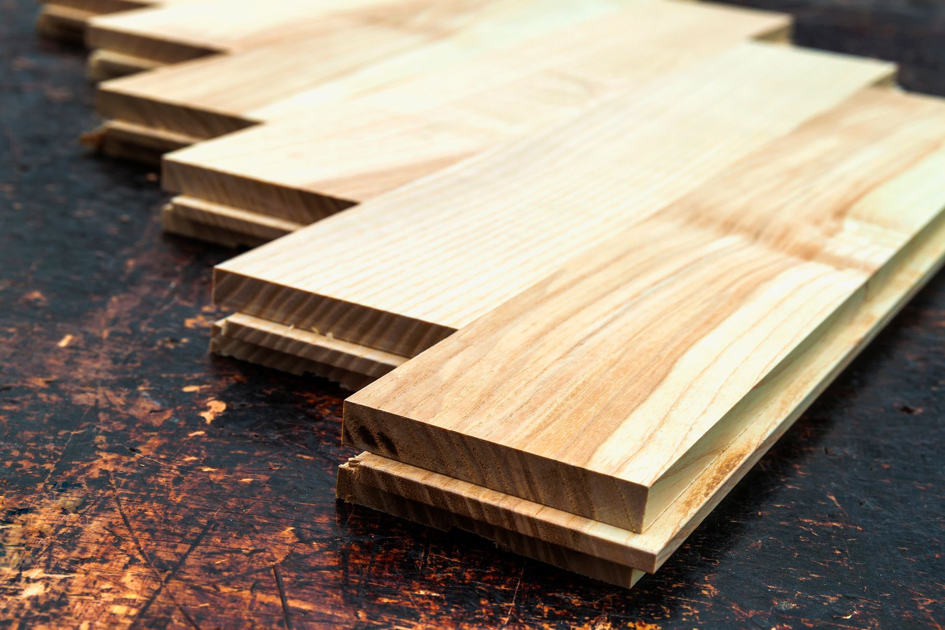 Wooden planks stacked, showing the edges with grooved sides.