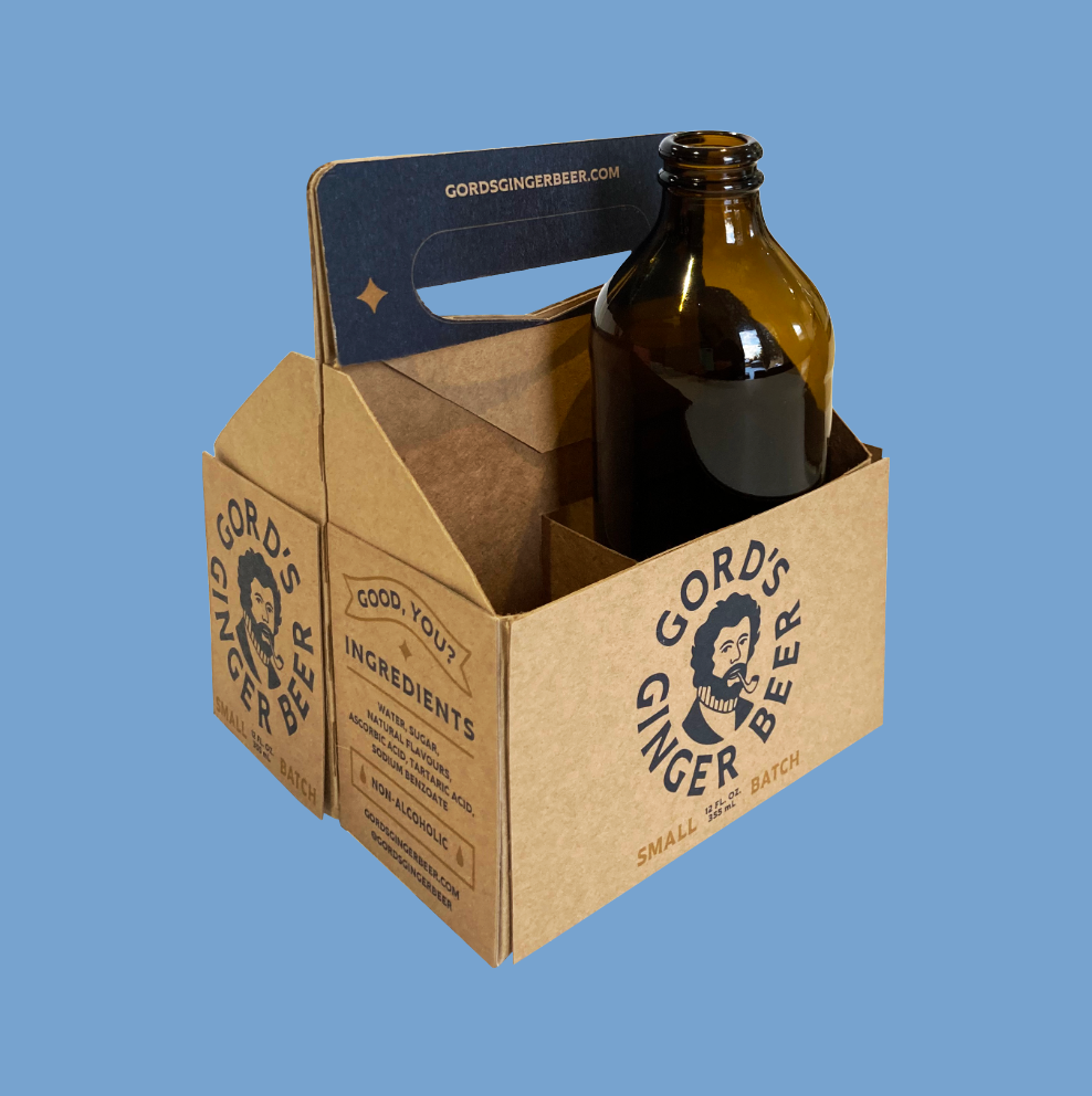 A bottle of goro 's ginger beer in a cardboard box