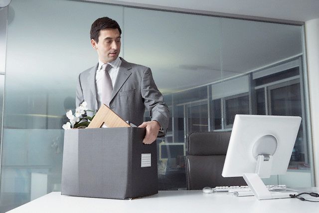 Businessman with cardboard box --- Image by © Nic Ortega/Corbis