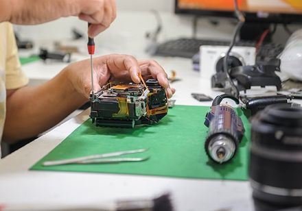 Technician repairing camera