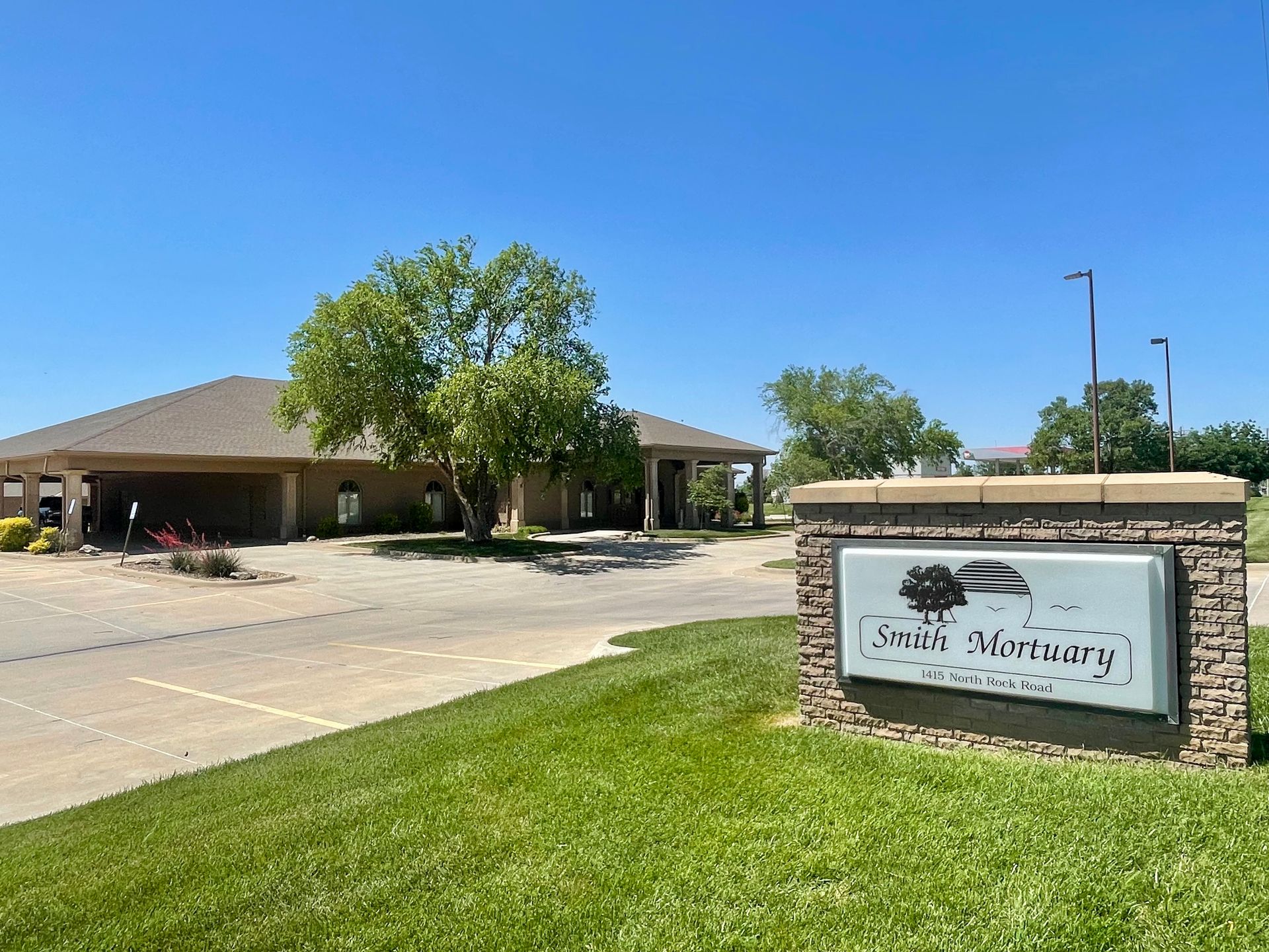 A large building with a sign in front of it.