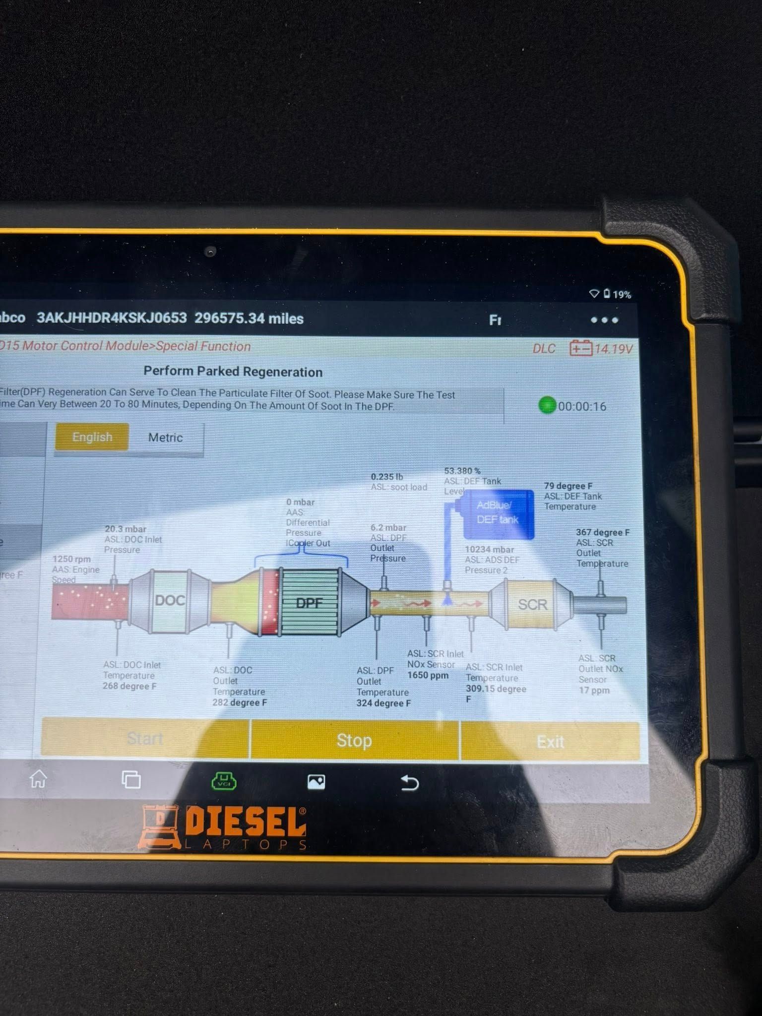 A tablet screen displays a technical diagram of a vehicle exhaust aftertreatment system with labeled components.