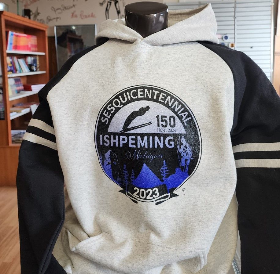 Gray and black hoodie with a Sesquicentennial Ishpeming Michigan logo.