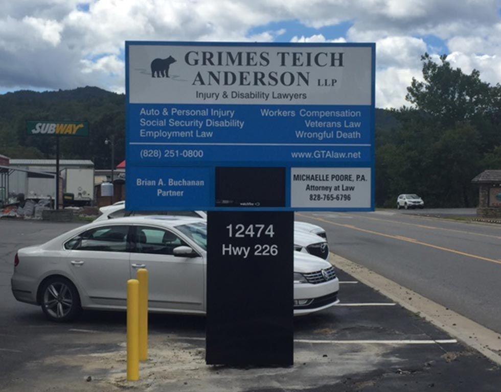 Sign for Grimes Teich Anderson law firm at 12474 Hwy 226, with blue and white text, includes services and contact info, beside a Subway.