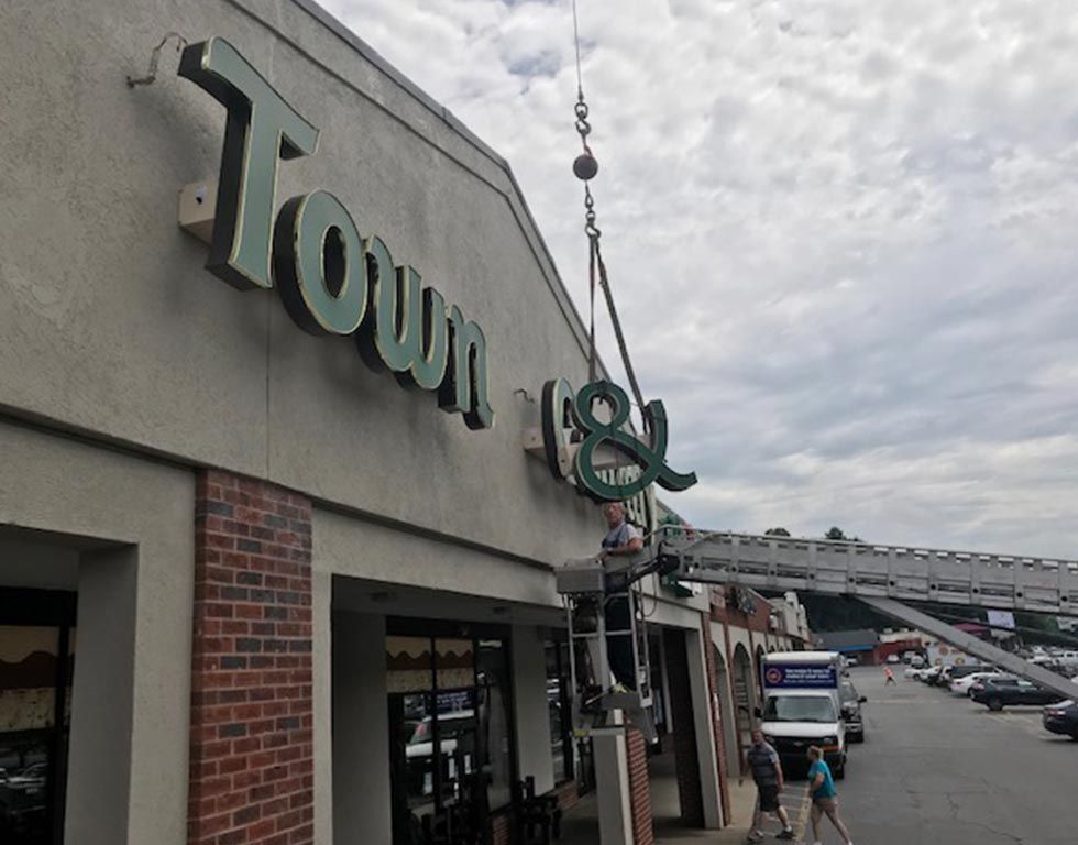 Workers using a crane remove the 