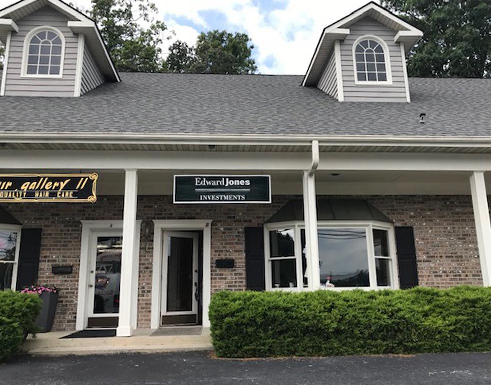 Exterior view of a brick building with a sign that reads 
