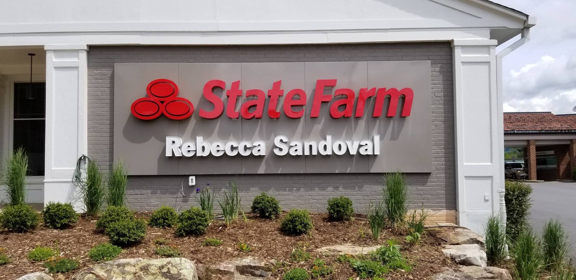 A State Farm office sign with the name 