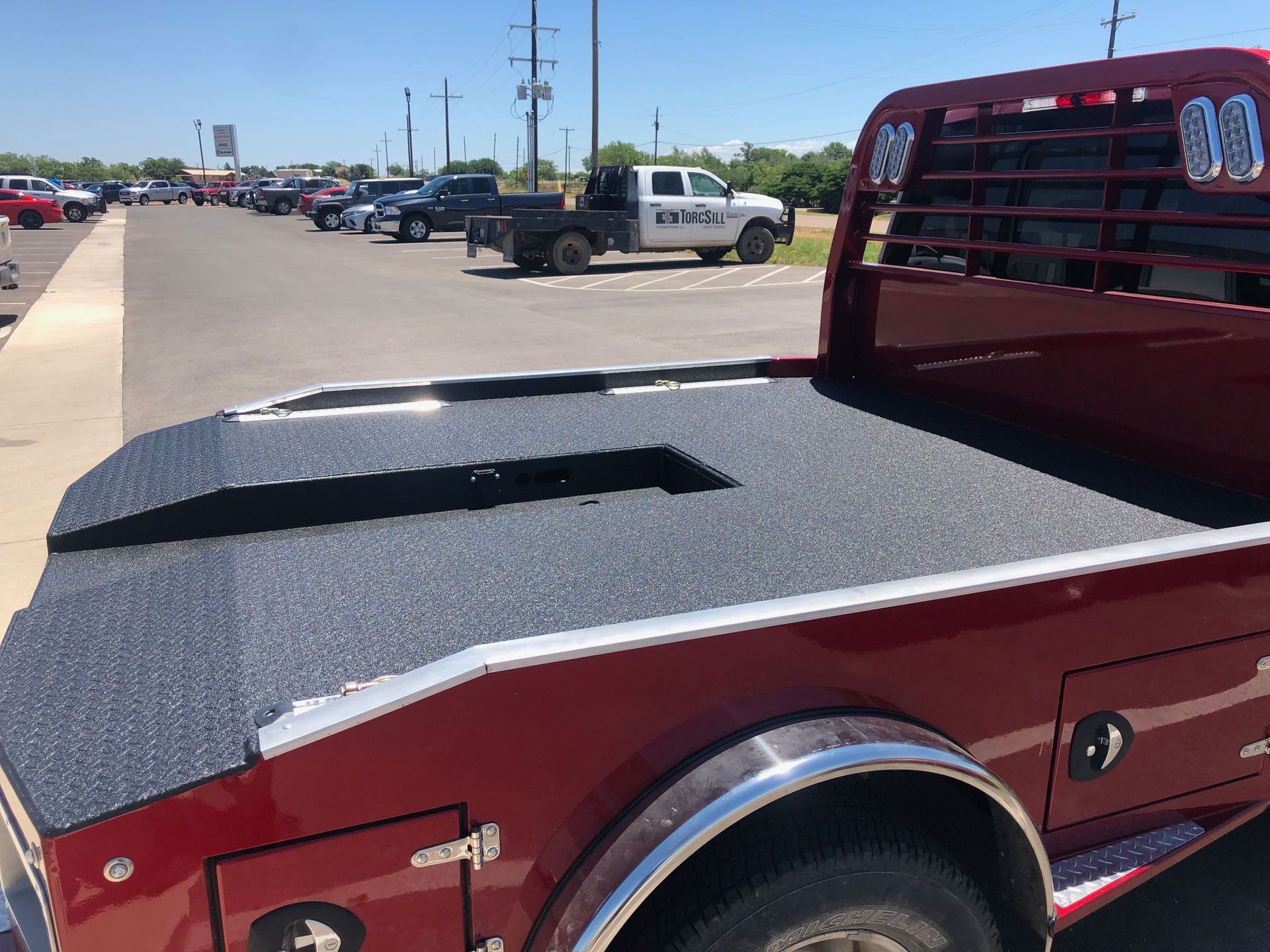 A red truck is parked in a parking lot.
