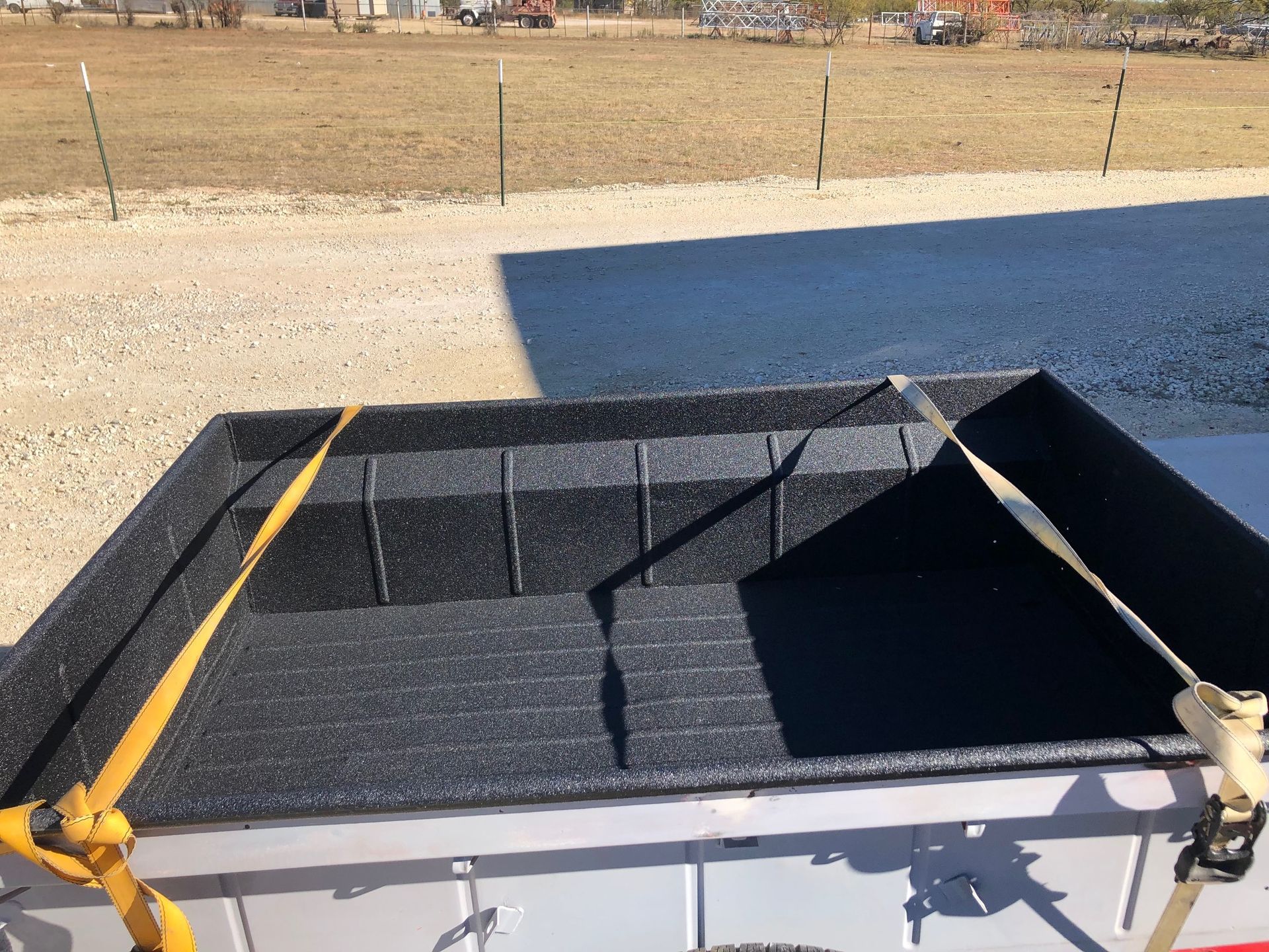 A black box with a yellow strap on top of it