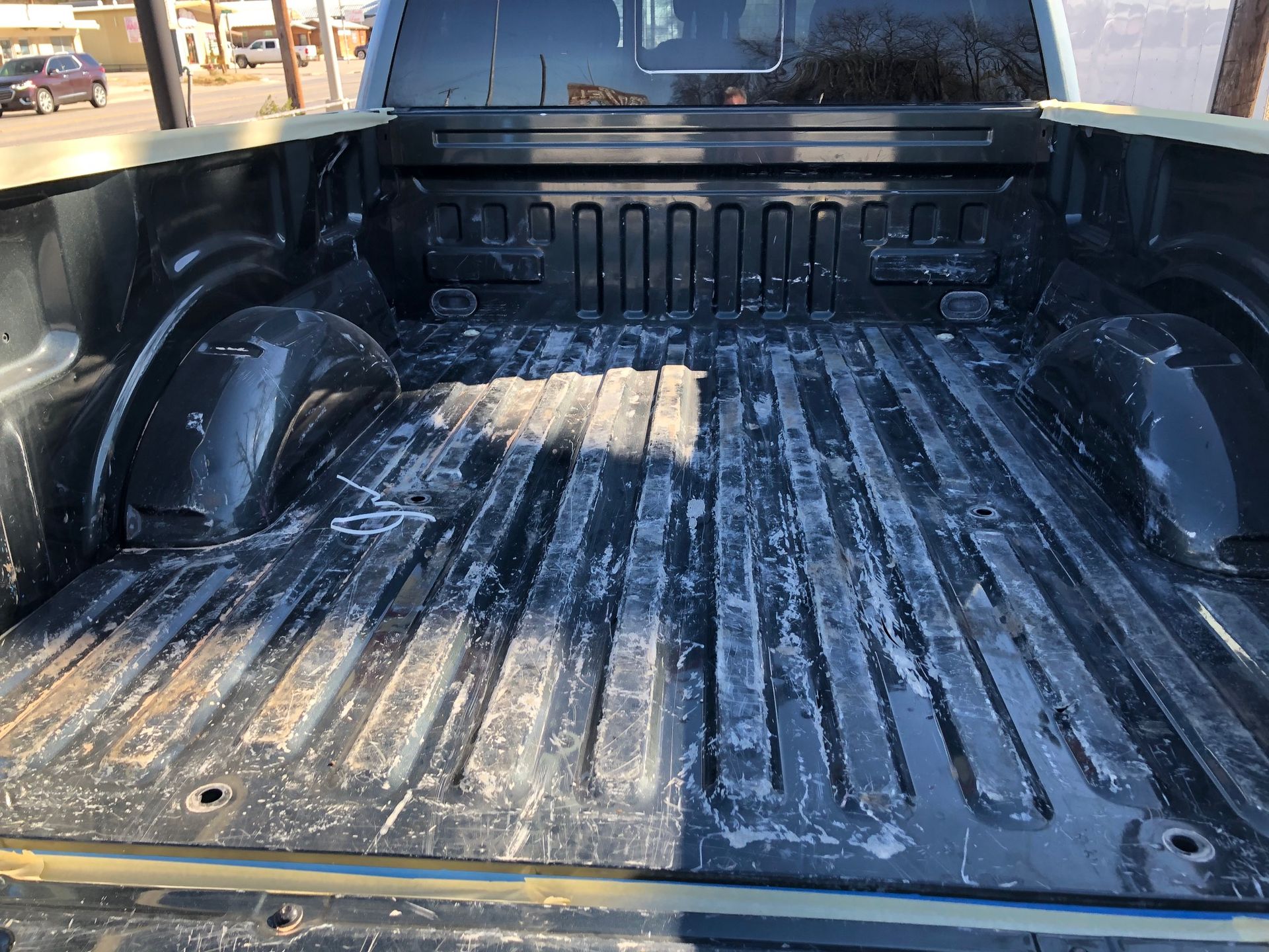 The back of a truck with a dirty bed