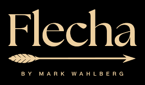Logo for Flecha by Mark Wahlberg: gold text and arrow on black background.