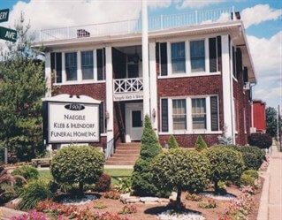 A large brick building with a sign that says ' funeral home ' on it