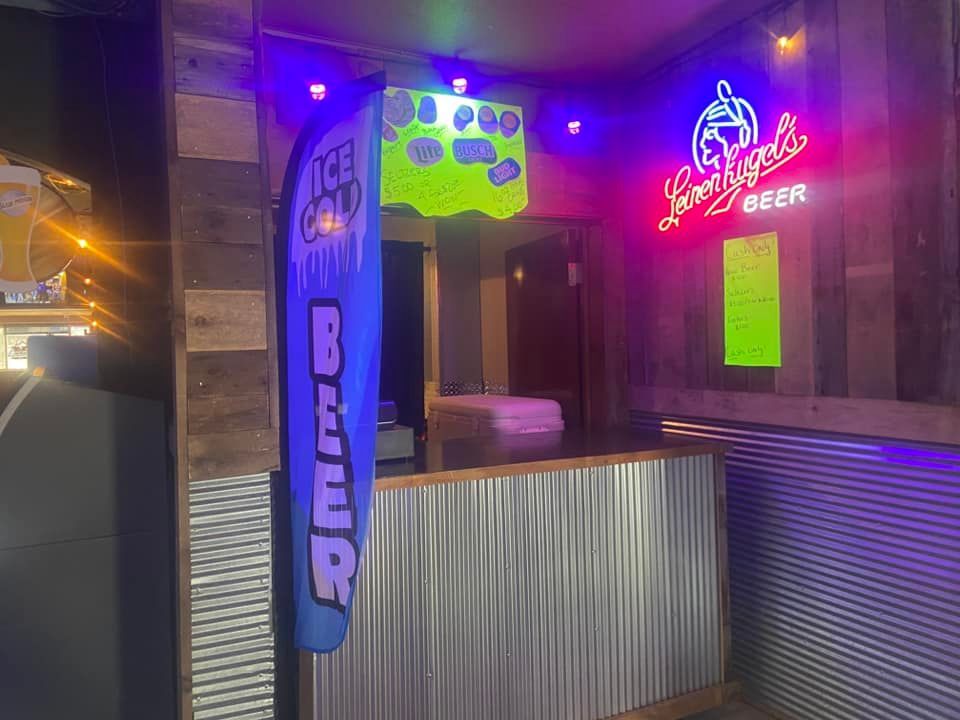 Bar with corrugated metal, wood, neon signs: 