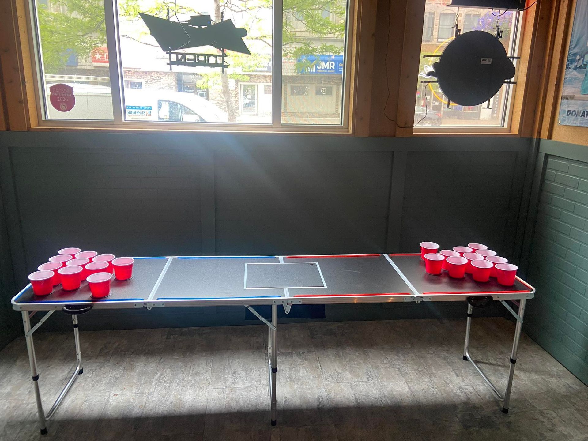 Beer pong table set up with red cups.
