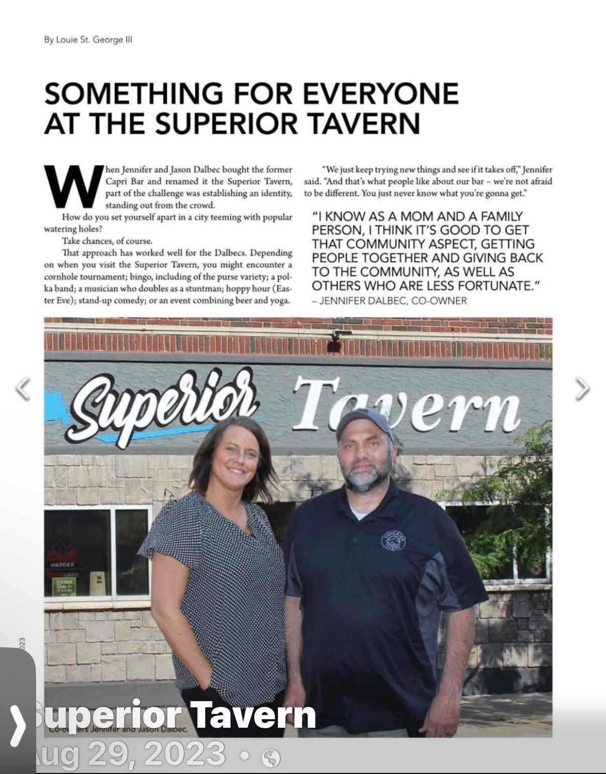 Two people stand in front of the Superior Tavern. Woman on left, man on right, text above.