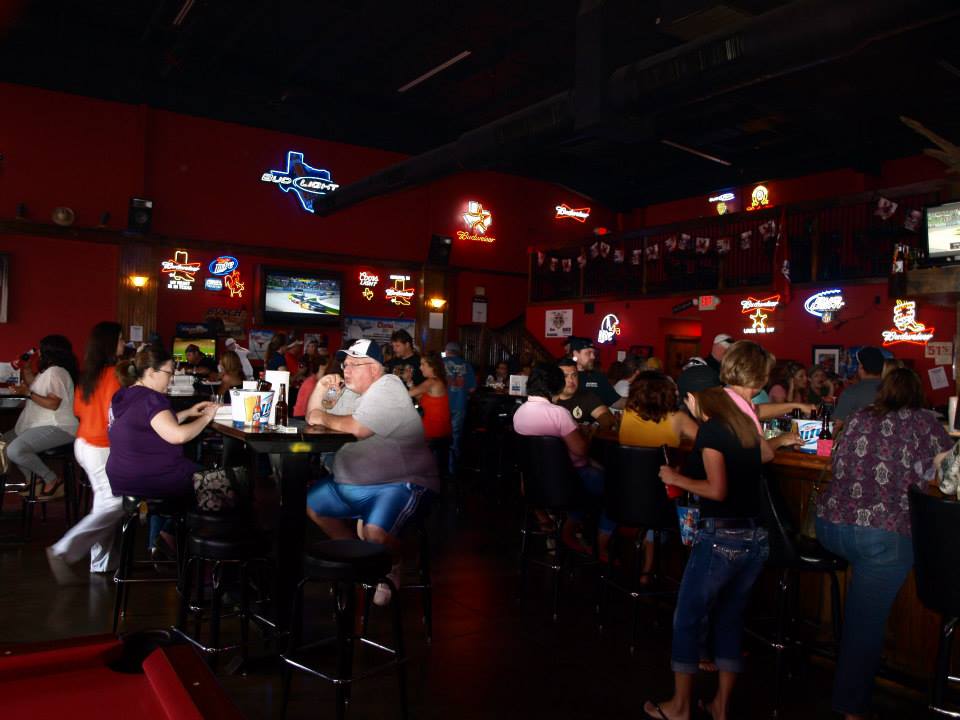 people at the bar listening to live music
