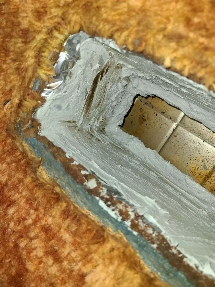 A close up of a piece of metal covered in white paint.