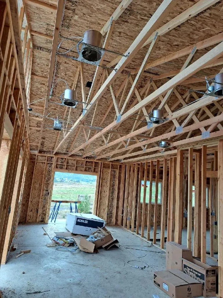 The inside of a house under construction with a lot of wooden beams.