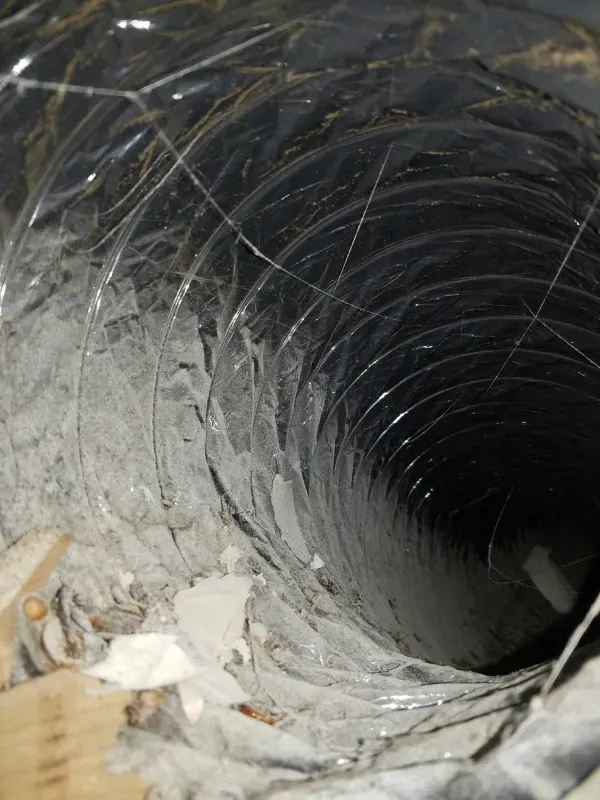 A close up of a duct with a hole in it.
