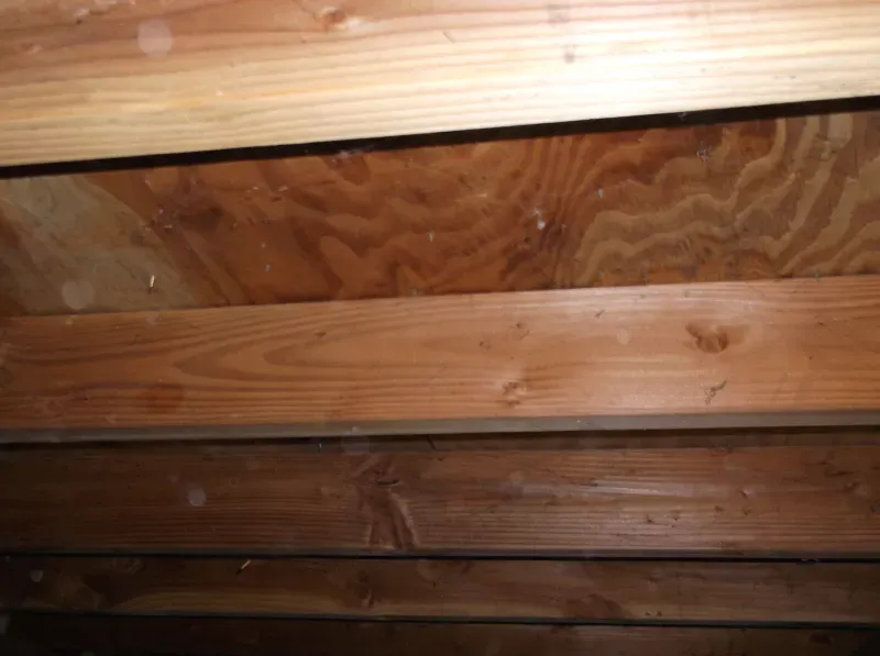 A close up of a wooden ceiling with a lot of wood.