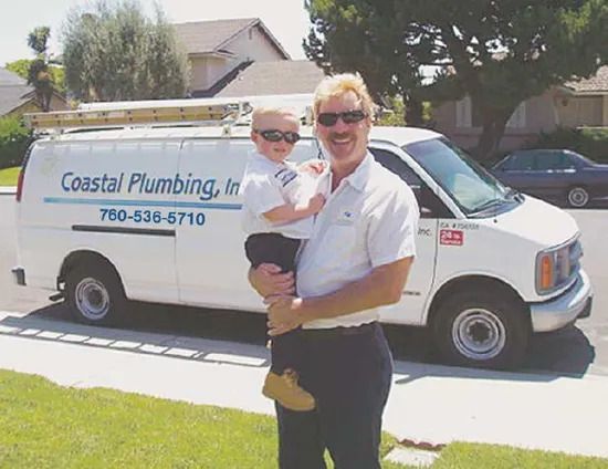 Man Holding Little Boy — Vista, CA — Coastal Plumbing Inc