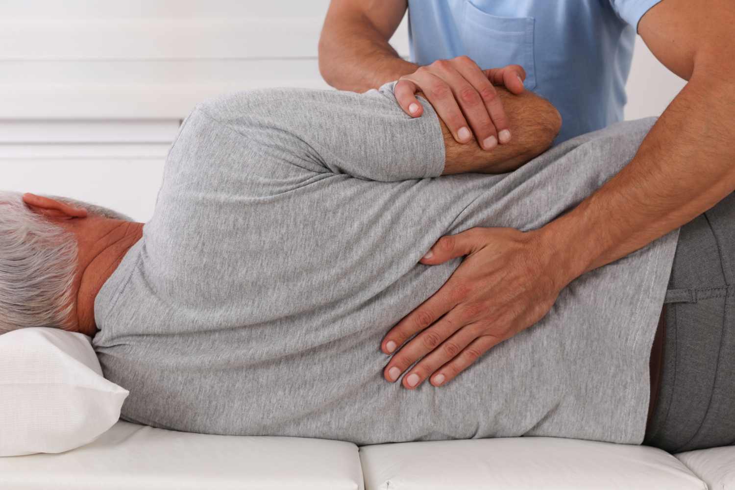 chiropractor helping a patient with lower back pain