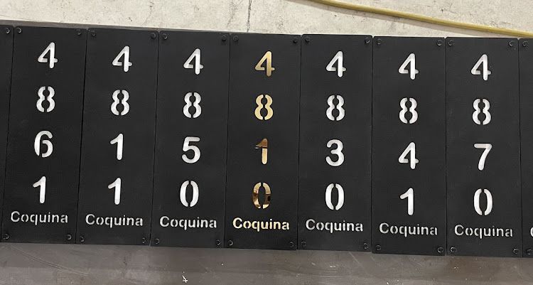 Eight black signs with white numbers and the word 