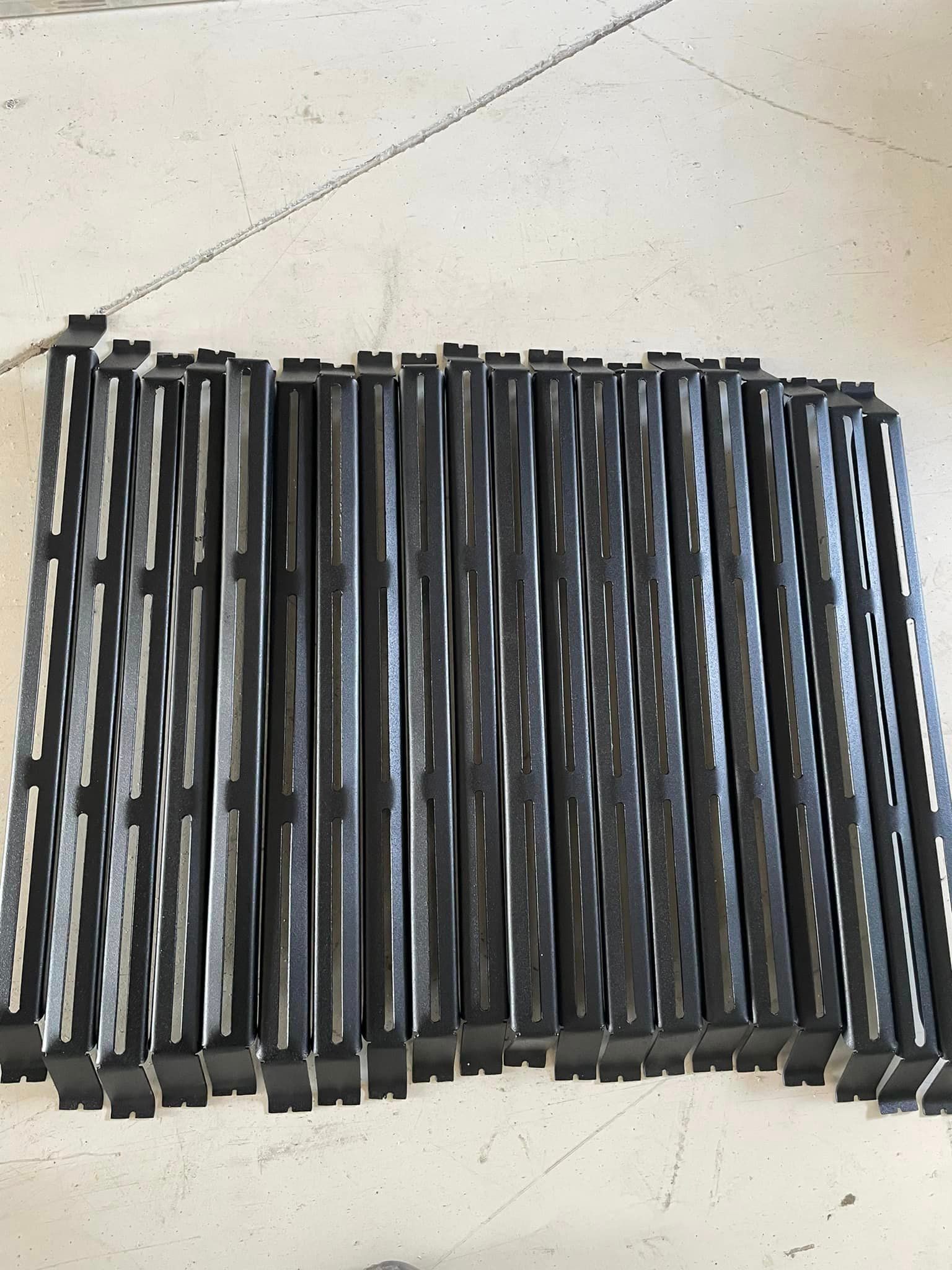 Black metal frames laid out on a light-colored surface, possibly for construction.