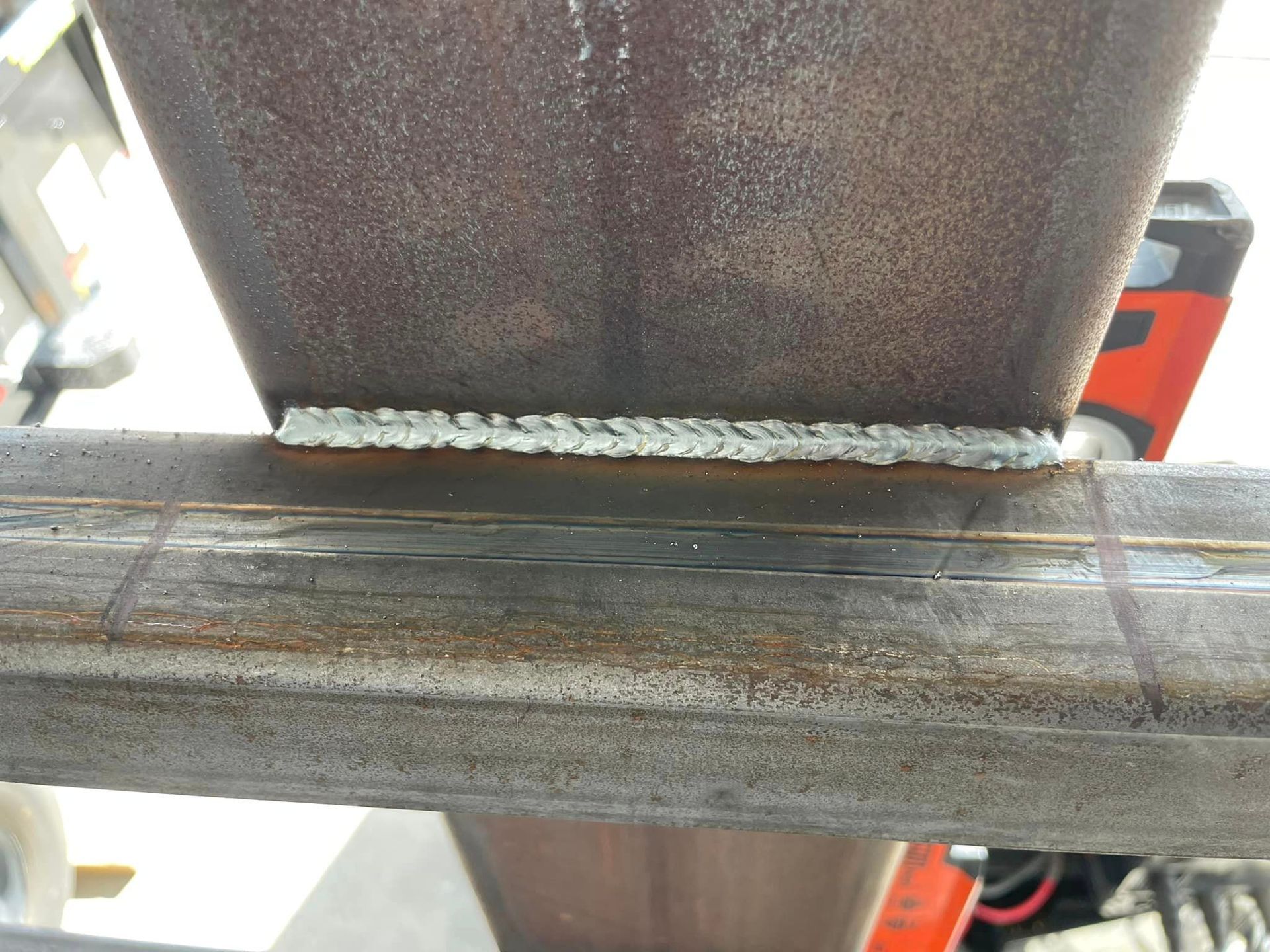 Steel beams welded together, showcasing a close-up view of the weld bead.