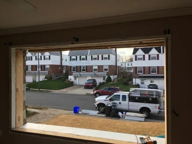 A truck is parked in front of a house in a residential area.