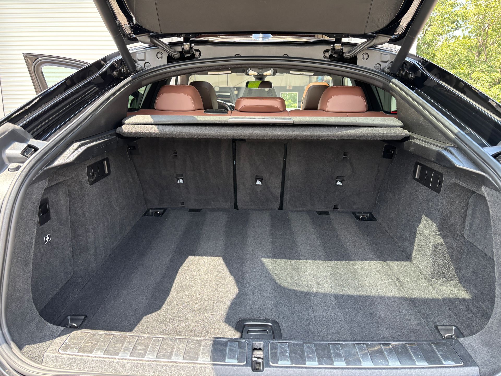Stack of colorful, textured buffing pads in a storage area, varying shades of blue, black, and orange.