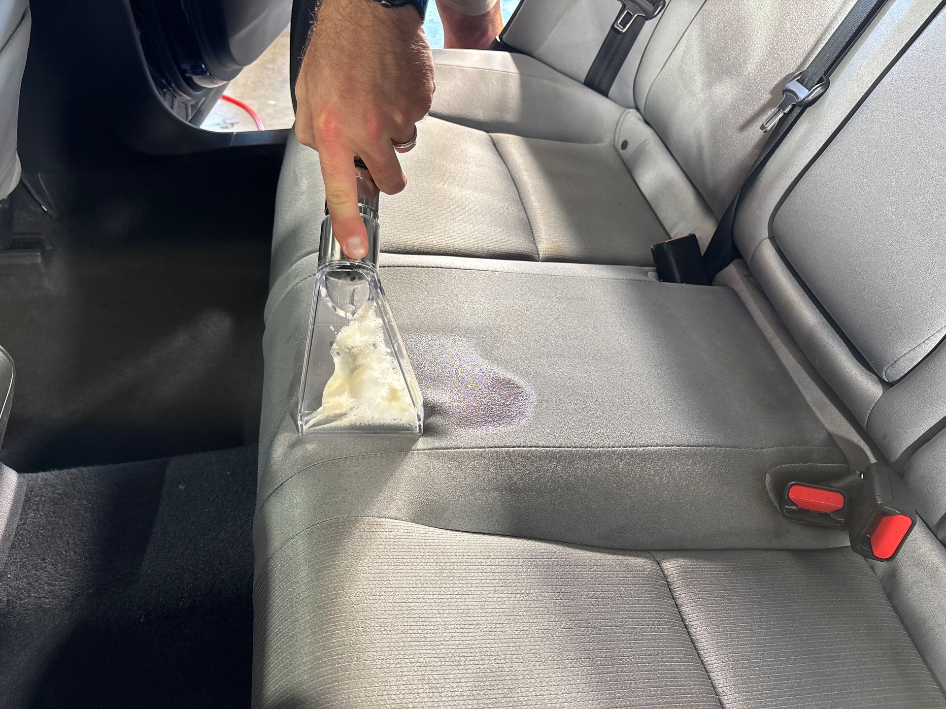 Blue Honda Accord parked in front of a gray building on a sunny day.